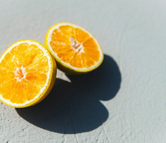 면역력 강화하는 비타민과 미네랄이 풍부한 식단 two oranges cut in half sitting on a table