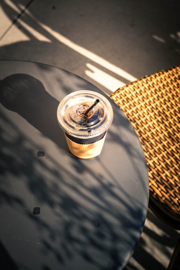 Iced coffee on a table with dappled sunlight
