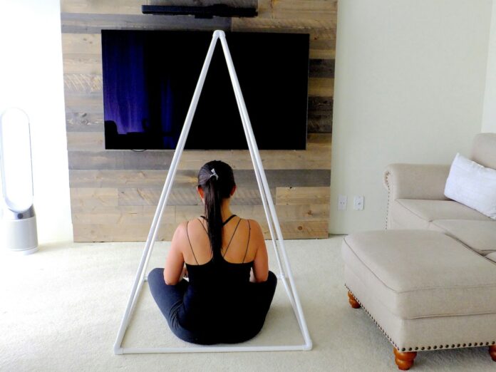 woman sitting in white triangle rods
