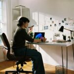 디지털 디톡스, 당신의 삶에 여유를 더하다 Person working at desk with laptop and phone.